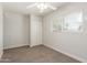Well-lit bedroom featuring plush carpet, ceiling fan, and a window with bright sunlight at 14846 N 29Th Ave, Phoenix, AZ 85053