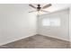 Clean, neutral carpet, ceiling fan, and window in a simple yet functional bedroom at 14846 N 29Th Ave, Phoenix, AZ 85053