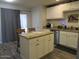 Kitchen boasts an island, granite countertops, and white cabinetry at 14846 N 29Th Ave, Phoenix, AZ 85053