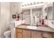 Clean bathroom with granite countertop, wood cabinets, and a shower at 14950 W Mountain View Blvd # 3209, Surprise, AZ 85374