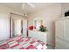 Spacious bedroom with white dresser, mirror, and red and white bedding at 14950 W Mountain View Blvd # 3209, Surprise, AZ 85374