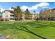 Apartment building exterior with green landscaping and mature trees at 14950 W Mountain View Blvd # 3209, Surprise, AZ 85374