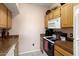 Cozy kitchen features wood cabinets, granite counters, and modern appliances at 14950 W Mountain View Blvd # 3209, Surprise, AZ 85374