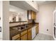 Well-equipped kitchen with stainless steel sink and wood cabinets at 14950 W Mountain View Blvd # 3209, Surprise, AZ 85374