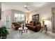 Relaxing living room featuring a brown leather couch and tiled floors at 14950 W Mountain View Blvd # 3209, Surprise, AZ 85374