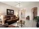 Spacious living room with tiled floors and access to other rooms at 14950 W Mountain View Blvd # 3209, Surprise, AZ 85374