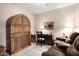Charming home office with wood armoire, comfortable couch, and built-in shelving at 14950 W Mountain View Blvd # 3209, Surprise, AZ 85374