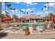Relaxing pool area with ample lounge chairs and umbrellas at 14950 W Mountain View Blvd # 3209, Surprise, AZ 85374