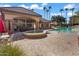 Community pool with fountain, lounge chairs, and building at 14950 W Mountain View Blvd # 3209, Surprise, AZ 85374