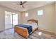 Bedroom with ceiling fan and access to backyard patio at 15200 S Diablo Rd, Arizona City, AZ 85123