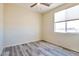 Well-lit bedroom with wood-look floors and ceiling fan at 15200 S Diablo Rd, Arizona City, AZ 85123