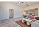 Open living room with L-shaped sofa and view of kitchen at 15200 S Diablo Rd, Arizona City, AZ 85123