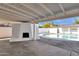 Covered patio with white brick fireplace and pool view at 1546 E 3Rd St, Mesa, AZ 85203