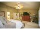 Main bedroom with a wooden poster bed, dresser, and ceiling fan at 16348 W Marconi Ave, Surprise, AZ 85388