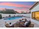 Relaxing pool area with seating and a beautiful sunset at 16442 N 58Th St, Scottsdale, AZ 85254