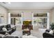 Bright living room with large windows, leather sofas, and a view of the backyard and pool at 1757 E Saltsage Dr, Phoenix, AZ 85048