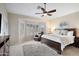 Large main bedroom with plush carpet, window seating and ceiling fan at 1757 E Saltsage Dr, Phoenix, AZ 85048