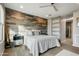 Spacious bedroom with wood-look walls, sliding barn door to the bathroom at 17835 E Woolsey Way, Rio Verde, AZ 85263