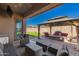 Covered patio offers ample seating with backyard views at 21754 E Caldwells Ct, Queen Creek, AZ 85142
