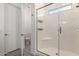 Bathroom showcasing a glass shower door, a tiled shower with a built-in seat, and bright lighting at 21754 E Caldwells Ct, Queen Creek, AZ 85142