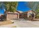 Spacious house featuring a three car garage, desert landscaping, and a well-maintained yard at 21754 E Caldwells Ct, Queen Creek, AZ 85142
