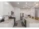 Modern kitchen featuring stainless steel appliances, granite countertops, and a view into the dining area at 21754 E Caldwells Ct, Queen Creek, AZ 85142