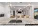 Open concept kitchen featuring granite countertops, stainless steel appliances, and a view into the living room at 21754 E Caldwells Ct, Queen Creek, AZ 85142