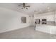 Open-concept living area with abundant natural light, tiled floors, and open flow to the kitchen at 21754 E Caldwells Ct, Queen Creek, AZ 85142