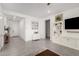 Bright living room features neutral walls, tile flooring, and stylish white built-in shelving at 21754 E Caldwells Ct, Queen Creek, AZ 85142