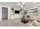 Bright living room featuring a comfortable sectional sofa, built in shelving, and lots of natural light at 21754 E Caldwells Ct, Queen Creek, AZ 85142