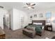 Cozy main bedroom featuring carpet floors, ceiling fan, and an en-suite bathroom at 21754 E Caldwells Ct, Queen Creek, AZ 85142
