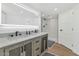 Modern bathroom with double sinks, white countertop, dark wood cabinets and a walk-in glass shower at 2323 N Central Ave # 502, Phoenix, AZ 85004