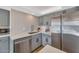 Close-up of a modern kitchen featuring stainless steel appliances, light countertops, and gray shaker cabinets at 2323 N Central Ave # 502, Phoenix, AZ 85004