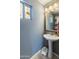 Well-appointed bathroom featuring a pedestal sink and mirror at 2403 W Via Dona Rd, Phoenix, AZ 85085