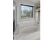 Clean bathroom with large soaking tub and window at 2403 W Via Dona Rd, Phoenix, AZ 85085