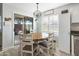 Eat-in kitchen with white cabinets, stainless steel appliances, and a round dining table at 2403 W Via Dona Rd, Phoenix, AZ 85085