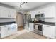 Modern kitchen with white cabinets, stainless steel appliances, and a breakfast nook at 2403 W Via Dona Rd, Phoenix, AZ 85085
