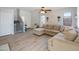 Bright living room with L-shaped sofa, wood-look floors, and stairs with a baby gate at 2403 W Via Dona Rd, Phoenix, AZ 85085