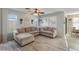 Spacious living room featuring a large L-shaped sectional sofa and wood-look floors at 2403 W Via Dona Rd, Phoenix, AZ 85085