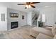 Living room with fireplace, L-shaped sofa and hardwood floors at 2403 W Via Dona Rd, Phoenix, AZ 85085