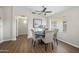 Well-lit dining room featuring wood floors, modern table and chairs, and a ceiling fan for comfortable dining at 2466 S Acanthus --, Mesa, AZ 85209