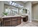 Double vanity bathroom with dark brown cabinets and plenty of counter space at 30407 N 54Th St, Cave Creek, AZ 85331