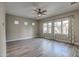 Spacious living room featuring wood-look tile floors and ceiling fan at 30407 N 54Th St, Cave Creek, AZ 85331