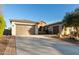 Single-story home with a two-car garage and desert landscaping at 32133 N 127Th Dr, Peoria, AZ 85383