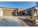 Two-car garage and walkway to entry with brick accents at 32133 N 127Th Dr, Peoria, AZ 85383