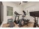 Home gym with treadmill, elliptical, and weights at 32133 N 127Th Dr, Peoria, AZ 85383