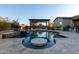 Luxury pool with a central water feature and pergola at 32133 N 127Th Dr, Peoria, AZ 85383