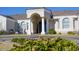 Inviting front entrance with columns, archway, and neatly landscaped grounds at 3528 E Decatur St, Mesa, AZ 85213