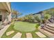 Landscaped backyard with putting green and stone pathways at 37181 N 103Rd St, Scottsdale, AZ 85262