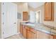 Bathroom with wood cabinets and tiled countertop at 37181 N 103Rd St, Scottsdale, AZ 85262